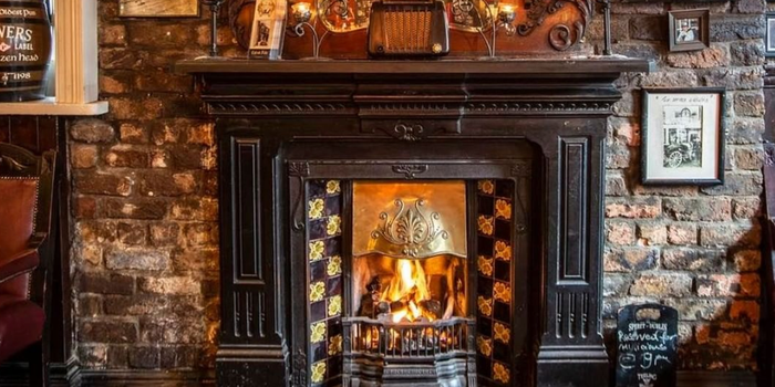 old fashioned fireplace with an open fire in the Brazen Head pub, Dublin