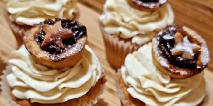 cupcakes with frosting and mince pies sitting on top