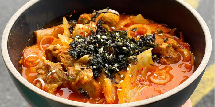 bowl of kimchi stew with seaweed gim and rice