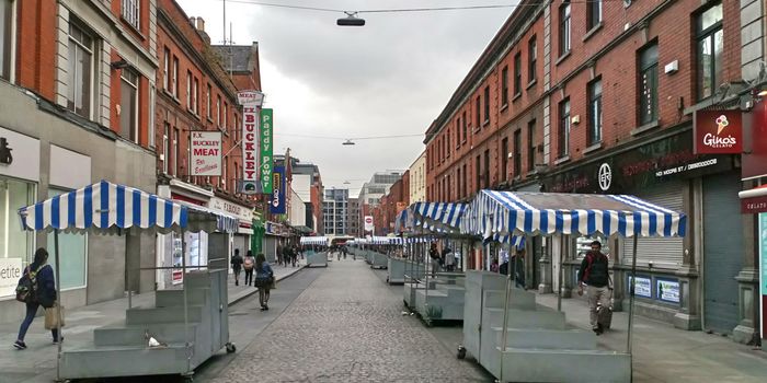 empty stalls with blue and white striped canopies on Moore Street