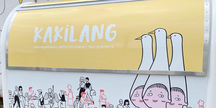 Kakilang food trailer with colourful illustrations on the walls and a yellow hatch