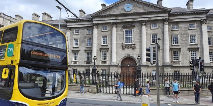 exterior shot of college green in dublin with bus driving past