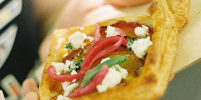 pastry with crumbled feta and pickled onions