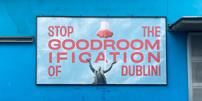 billboard with pale blue background and illustrations of lampshade and Jim Larkin reads "stop the goodroomification of Dublin!"
