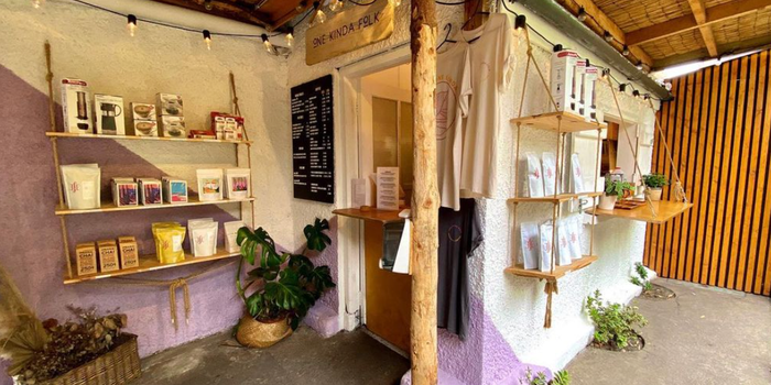 one kinda folk coffee shed, with purple and white coloured walls and shelves filled with coffee equipment