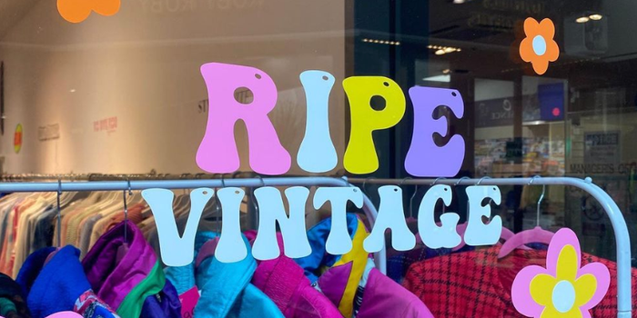 colourful window decal for Ripe Vintage clothing store with bubble letters and flowers