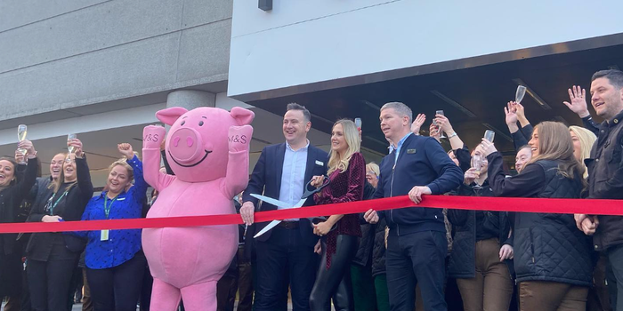 Percy Pig and M&S staff cutting a ribbon outside the opening of a new store