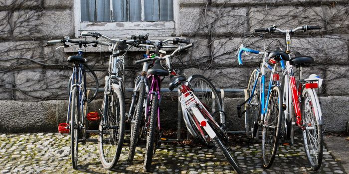 several bikes parked up at a bike rack