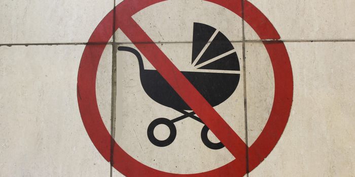 sign showing a red cross over a baby pram to indicate "no children"