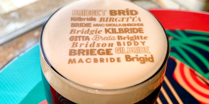 a pint of guinness with the various derivatives of the name Brigid printed on top