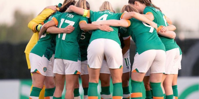 Irish women's football team in a huddle during a match