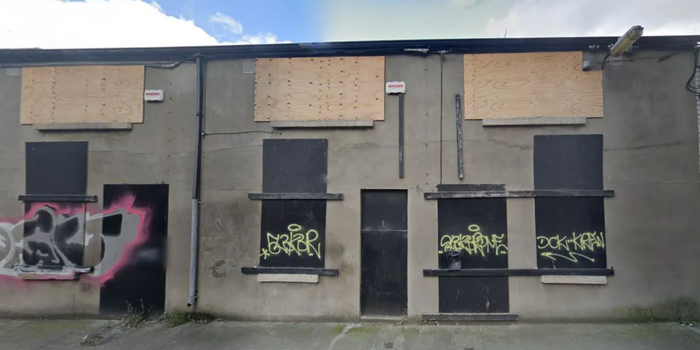 a derelict building with boarded up windows in dublin