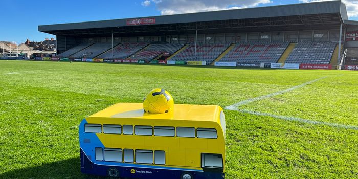 mini dublin bus carrying a ball on the pitch at dalymount park